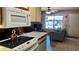 This charming kitchen features white appliances and overlooks a cozy living room with natural light at 1440 N Idaho Rd # 1022, Apache Junction, AZ 85119