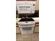 Close-up of a modern, white electric stovetop with matching microwave above at 1440 N Idaho Rd # 1022, Apache Junction, AZ 85119