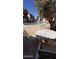 Relaxing poolside seating area with table and chairs near lush landscaping at 1440 N Idaho Rd # 1022, Apache Junction, AZ 85119