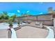 Charming backyard featuring a built-in BBQ, pool, and beautiful desert landscaping at 1623 E Runion Dr, Phoenix, AZ 85024