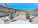 The backyard has a grill, and landscaped hardscape and desert scenery at 1623 E Runion Dr, Phoenix, AZ 85024