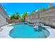 Charming backyard featuring a built-in BBQ, pool, and beautiful desert landscaping at 1623 E Runion Dr, Phoenix, AZ 85024