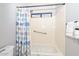 Bright bathroom featuring a tub and shower combination with colorful decorative curtain at 1623 E Runion Dr, Phoenix, AZ 85024