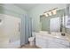 Well-lit bathroom featuring a tub with shower, vanity with sink, and a neutral color palette at 1623 E Runion Dr, Phoenix, AZ 85024