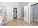 Bathroom with tile floors leading to walk-in closet with custom shelving and drawers at 1623 E Runion Dr, Phoenix, AZ 85024