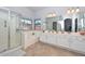 Bright bathroom with walk-in shower, tub, double sink vanity, and neutral tile floor at 1623 E Runion Dr, Phoenix, AZ 85024
