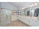 Bathroom with dual sinks and shower, as well as a separate door leading to the toilet area at 1623 E Runion Dr, Phoenix, AZ 85024
