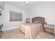 Cozy bedroom with tile flooring, neutral walls, and a comfortable bed with side tables at 1623 E Runion Dr, Phoenix, AZ 85024
