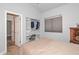 Neutral bedroom featuring a built-in closet, a window with blinds, and neutral tile flooring at 1623 E Runion Dr, Phoenix, AZ 85024