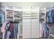 Walk-in closet with custom shelving, drawers, and hanging rods for optimal storage at 1623 E Runion Dr, Phoenix, AZ 85024