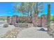 Stone sign for Scarlet Canyon community with desert landscaping, including cacti and trees under a bright blue sky at 1623 E Runion Dr, Phoenix, AZ 85024