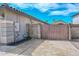 Driveway gate next to block fence, showcasing property's exterior at 1623 E Runion Dr, Phoenix, AZ 85024