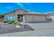 Inviting single-story home with a two-car garage, well-maintained desert landscaping, and a tile roof at 1623 E Runion Dr, Phoenix, AZ 85024