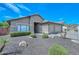 Charming single-story home with neutral stucco, tile roof, two-car garage, and low-maintenance desert landscaping at 1623 E Runion Dr, Phoenix, AZ 85024
