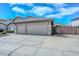 Spacious two-car garage with extended driveway and low-maintenance desert landscaping, providing ample parking at 1623 E Runion Dr, Phoenix, AZ 85024