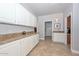 Hallway featuring built in cabinets, granite countertop and access to multiple rooms at 1623 E Runion Dr, Phoenix, AZ 85024