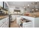 Featuring stainless steel appliances, white cabinets, and smart storage solutions, this kitchen is a chef's dream at 1623 E Runion Dr, Phoenix, AZ 85024