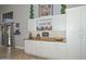 Butler's pantry featuring white cabinets, granite countertops, and convenient pull-out shelves for storage at 1623 E Runion Dr, Phoenix, AZ 85024