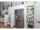 Kitchen area boasts stainless steel refrigerator, and white cabinets with pull-out storage for easy organization at 1623 E Runion Dr, Phoenix, AZ 85024