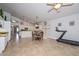 Spacious open-concept kitchen with white cabinets, stainless steel appliances, and a dining area with abundant natural light at 1623 E Runion Dr, Phoenix, AZ 85024