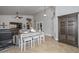Open-concept living area featuring a kitchen table, tile flooring, and a view of the entryway at 1623 E Runion Dr, Phoenix, AZ 85024
