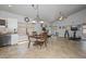 Open concept living space featuring a dining area, kitchen, and home gym with natural light and tile flooring at 1623 E Runion Dr, Phoenix, AZ 85024