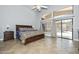 Spacious main bedroom featuring a large window overlooking the pool and stone waterfall at 1623 E Runion Dr, Phoenix, AZ 85024