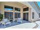 Staged covered patio with seating area and multiple sliding doors to home interior at 1623 E Runion Dr, Phoenix, AZ 85024