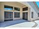 Bare covered patio with multiple sliding doors to home interior at 1623 E Runion Dr, Phoenix, AZ 85024