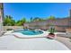 A stunning pool with a rock feature and a built-in BBQ, creating a luxurious outdoor oasis at 1623 E Runion Dr, Phoenix, AZ 85024