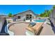 An inviting pool area with lush plants, a built-in BBQ, and a red brick patio, ideal for outdoor gatherings at 1623 E Runion Dr, Phoenix, AZ 85024