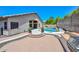 A captivating pool featuring lush potted plants, a built-in BBQ, and a red brick patio, perfect for relaxation at 1623 E Runion Dr, Phoenix, AZ 85024