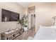 Bedroom with modern decor and wood-look tile flooring with a mounted flat screen tv at 1633 E Lakeside Dr # 156, Gilbert, AZ 85234