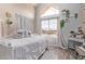 A bedroom features a large window with wood-look tile floors and neutral paint at 1633 E Lakeside Dr # 156, Gilbert, AZ 85234