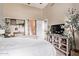 Bright bedroom features a high ceiling, wood-look tile floors, and a decorative media console at 1633 E Lakeside Dr # 156, Gilbert, AZ 85234
