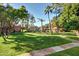 Picturesque common area featuring a pool, shaded cabanas, and lush landscaping, perfect for relaxation and recreation at 1633 E Lakeside Dr # 156, Gilbert, AZ 85234