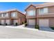 Exterior shot of townhomes with garages and well-maintained landscaping under a sunny sky at 1633 E Lakeside Dr # 156, Gilbert, AZ 85234