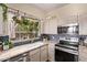 Bright kitchen features hexagon tile backsplash, granite countertops, and a stainless steel oven range at 1633 E Lakeside Dr # 156, Gilbert, AZ 85234