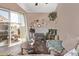 Living room with glass door to patio and a decorative fireplace with wicker-themed wall decor at 1633 E Lakeside Dr # 156, Gilbert, AZ 85234