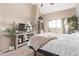 Light filled bedroom with modern décor, wooden floors and a large window at 1633 E Lakeside Dr # 156, Gilbert, AZ 85234
