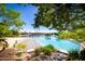 Stunning zero-entry pool with sandy beach area, surrounded by lush landscaping and mature trees at 1633 E Lakeside Dr # 156, Gilbert, AZ 85234