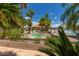 Attractive community pool and spa area with tropical landscaping and views of the lake at 1633 E Lakeside Dr # 156, Gilbert, AZ 85234