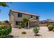 Two-story home featuring minimal xeriscaping and low water plants in the backyard at 16450 W Lilac St, Goodyear, AZ 85338