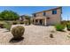Backyard featuring gravel landscaping, mature plants, and a covered patio for outdoor enjoyment at 16450 W Lilac St, Goodyear, AZ 85338