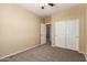 Bedroom featuring neutral walls, carpet, ceiling fan, and a closet for ample storage at 16450 W Lilac St, Goodyear, AZ 85338
