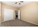 Bedroom featuring neutral walls, carpet, ceiling fan, and an open view of an attached bathroom at 16450 W Lilac St, Goodyear, AZ 85338