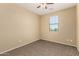 Comfortable bedroom with neutral walls, carpet flooring, ceiling fan, and a window for natural light at 16450 W Lilac St, Goodyear, AZ 85338