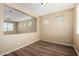 Bright room with wood flooring and large opening for entertaining or relaxing at 16450 W Lilac St, Goodyear, AZ 85338