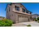 Corner view of the two-story home with a two-car garage, tiled roof, desert landscaping at 16450 W Lilac St, Goodyear, AZ 85338