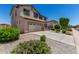 Two-story home with a two-car garage, tiled roof, desert landscaping, and covered entry at 16450 W Lilac St, Goodyear, AZ 85338